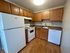 Inviting kitchen with warm wood cabinetry, sleek countertops, and modern appliances, ideal for culinary creativity.