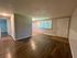 Inviting apartment interior with sleek hardwood floors, bright lighting, and a welcoming entrance area.