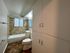 Contemporary bathroom with elegant tile design, bathtub, and ample storage, offering a serene and functional space.