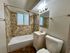 Chic bathroom featuring elegant tile work, a modern bathtub, and a stylish vanity for a soothing retreat.