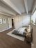 Inviting bedroom with modern decor, cozy bed, and large windows for natural light.