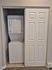 Convenient in-unit washer and dryer tucked behind a sleek sliding door in a modern apartment.