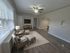 Elegant living room with modern decor, featuring comfortable seating, a stylish entertainment center, and inviting natural light.