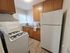 Charming kitchen with warm wooden cabinets, a bright window, and modern appliances, ideal for cozy home cooking.
