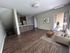Modern open-concept living area with hardwood floors, contemporary kitchen, and inviting patio access.