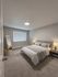 Elegant bedroom featuring a plush bed with stylish bedding, soft lighting, and a cozy ambiance perfect for relaxation.