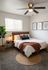 Cozy bedroom with modern decor, a comfortable bed, stylish artwork, and a charming plant accent.