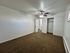 Bright and inviting bedroom with plush carpeting, ceiling fan, and ample closet space, ideal for comfort and relaxation.