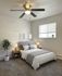 Inviting bedroom with modern decor, plush carpeting, and abundant natural light, featuring cozy bedding and stylish furnishings.