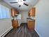 Charming kitchen with sleek wood cabinets, modern appliances, and elegant plank flooring, perfect for culinary creativity.