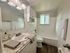 Bright bathroom with contemporary fixtures, elegant granite countertop, and soothing natural light.