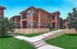 Charming apartment complex with modern architecture, lush greenery, and inviting walkways under a bright blue sky.