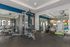 Modern fitness center equipped with state-of-the-art gym machines, exercise balls, and colorful fitness gear in a bright, spacious environment.