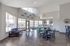 Bright and inviting community lounge featuring modern seating, large windows, and a chic kitchen area with patterned backsplash.