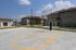 Inviting sports court with basketball hoop amidst modern apartment buildings under a clear blue sky.