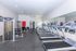 Modern fitness center with state-of-the-art treadmills, strength machines, and sleek design for an invigorating workout experience.