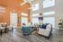 Inviting lounge area with modern decor, featuring high ceilings, abundant natural light, and cozy seating arrangements.