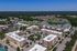 Aerial view of a vibrant residential complex surrounded by lush greenery and serene environments.
