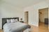Inviting bedroom with modern decor, a plush bed, and a spacious walk-in closet.