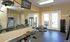 Well-equipped gym room with modern fitness machines and mirrored walls.