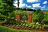 Beautifully landscaped entrance to Chester Village Green with vibrant flowers and a welcoming sign.