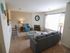 Inviting living room with modern furniture, large window, and warm lighting.