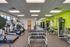 Modern fitness center featuring treadmills, weight racks, and diverse exercise equipment in a bright and inviting space.