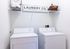Modern laundry area featuring a washer and dryer set with stylish storage solutions.