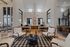 Stylish office lounge with wooden floors, chic seating, and modern decor.