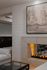 Cozy living room with an elegant fireplace, plush seating, and a serene landscape painting.