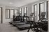Bright, fully-equipped gym with multiple treadmills and cardio machines, featuring large windows for natural light.