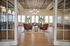 Stylish open lounge with elegant seating, modern lighting, and large windows.