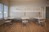 Stylish dining area with modern seating, wooden floors, and ambient lighting.