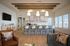 Modern lounge area with stylish seating, a sleek bar counter, and decorative ceiling beams.