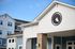 Elegant exterior of modern apartment complex with blue and white siding, showcasing architectural design and a serene atmosphere.