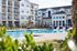 Stunning apartment complex with a sparkling pool and lush landscaping.