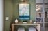 Charming corner nook with a stylish bird painting, modern wooden table, and cozy seating.