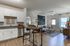 Inviting open-concept kitchen and living room with contemporary decor and natural light.