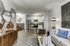 Modern open-plan living space with chic decor, featuring a stylish kitchen, cozy seating area, and elegant furnishings.