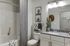 Sleek bathroom with modern fixtures, elegant granite countertop, and decorative touches.