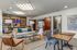 Stylish apartment lounge with modern furniture, wooden accents, and artistic decor.
