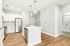 Contemporary kitchen with stainless steel appliances, white cabinetry, and an elegant island.