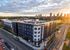 Stunning aerial view of Eastside Heights apartment complex with vibrant city skyline at sunset.