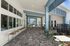 Spacious outdoor patio with stylish seating and modern architecture, featuring a covered area and scenic view.