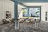 Contemporary outdoor lounge with stylish furniture, vibrant art, and a serene atmosphere surrounded by greenery.
