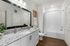 Chic and contemporary bathroom with granite countertop, large mirror, and stylish decor.