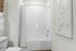 Bright bathroom featuring a modern bathtub with a striped shower curtain, white tiles, and a unique wall art piece.