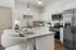 Elegant kitchen with granite countertops, modern appliances, and stylish bar stools.
