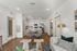 Bright modern living space with an open-concept kitchen and dining area, featuring sleek furniture and stylish decor.