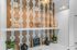 Stylish kitchen with decorative tile wall, plants, and elegant lighting.
